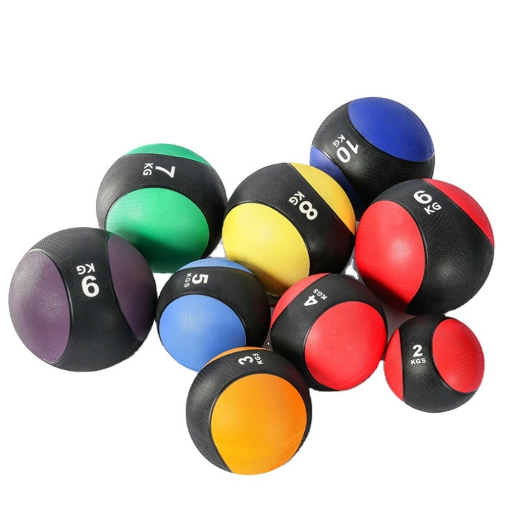 Colorful medicine balls of various weights on a white background
